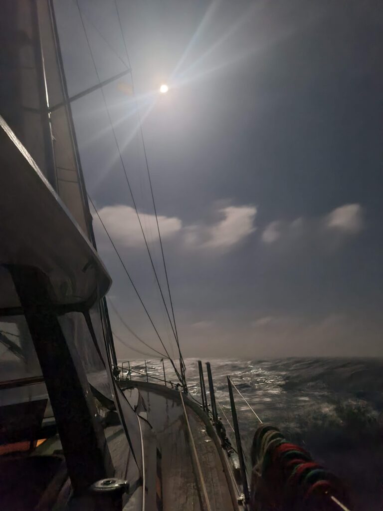 Sailboat at night under moonlight