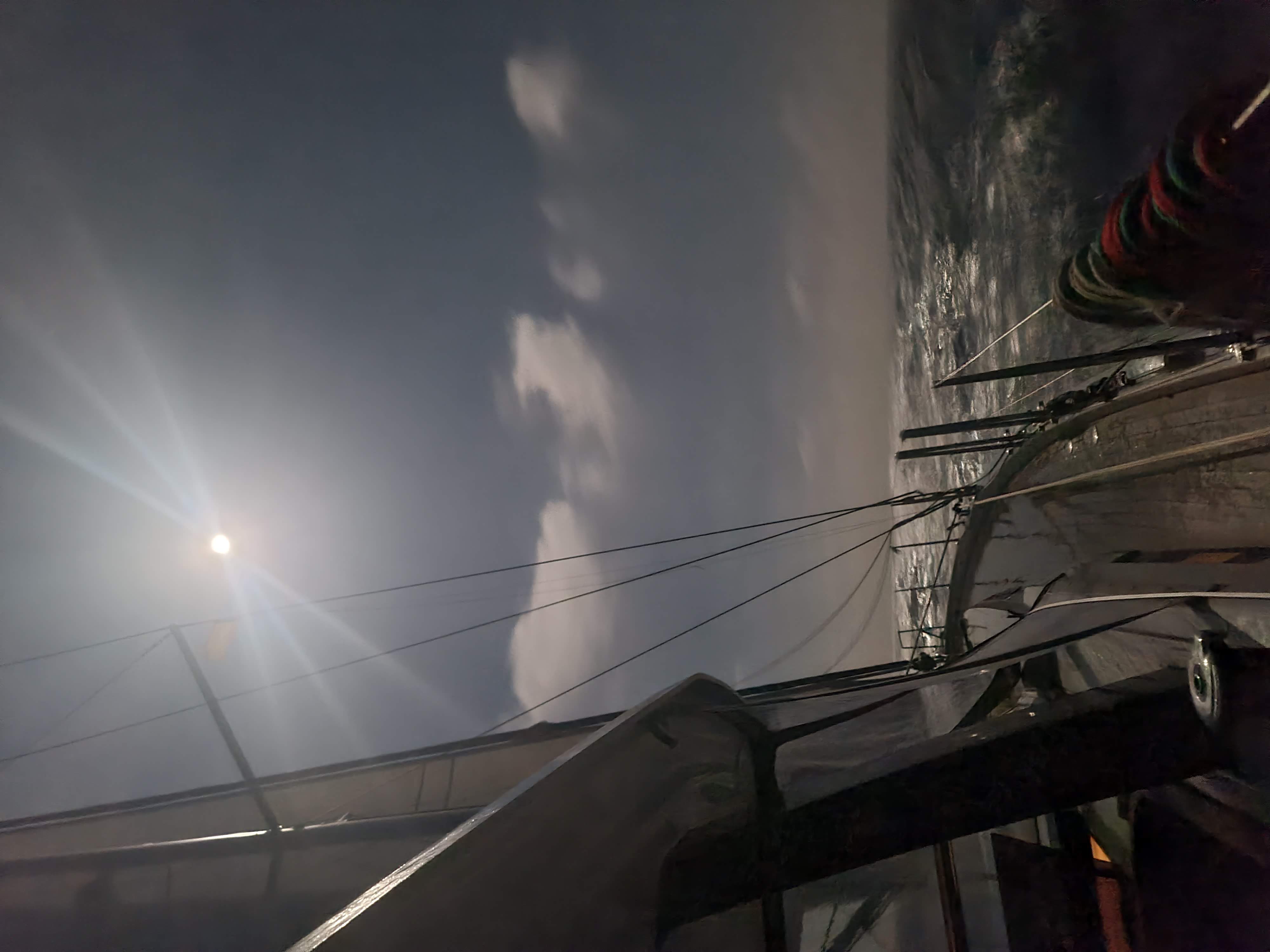 Sailboat at night under moonlight